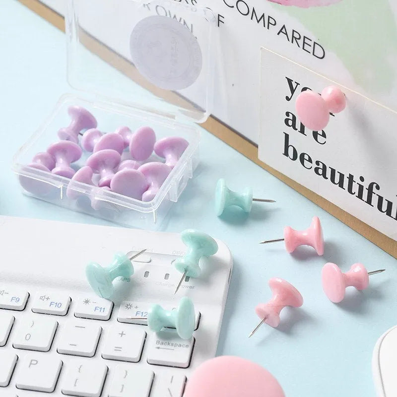 Plastic push pins in cherry blossom pink, mint green, and lavender colours, showing both large and small sizes on a white surface