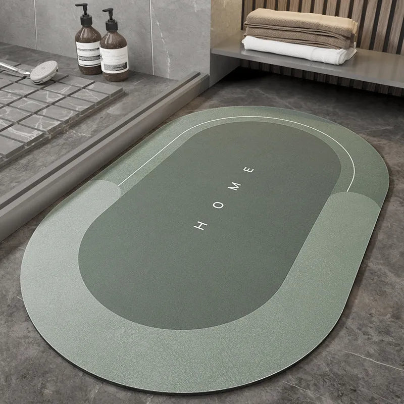 Machine-woven blended bathroom floor mat in blue, shown in an oval shape on a tiled floor.