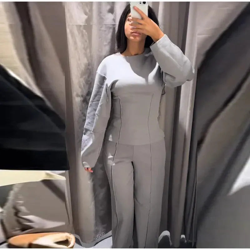 Women's black polar fleece suit set with pleated long sleeve top and wide leg trousers