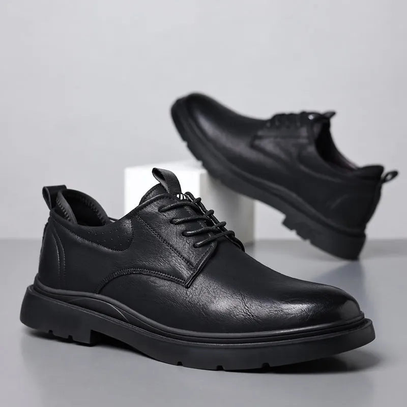 Men's black leather casual sneakers with sewing line detail and a rubber sole.