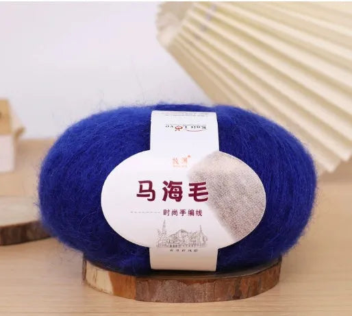 Ball of mohair yarn for DIY scarf knitting in one of 34 colours, including white, pink, blue, and green.