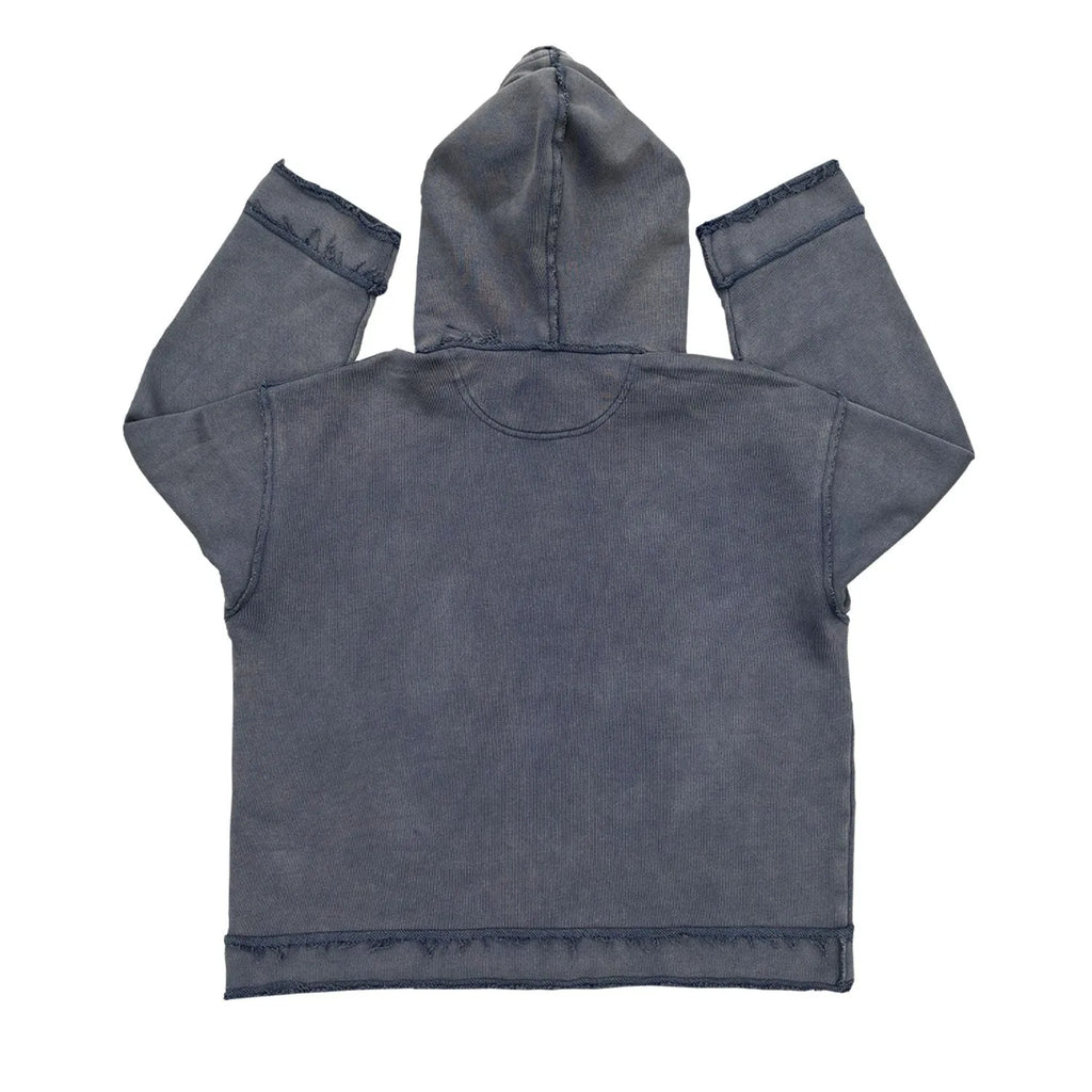 Reverse dark blue hoodie sweater on a model, showing knitted texture and hood.