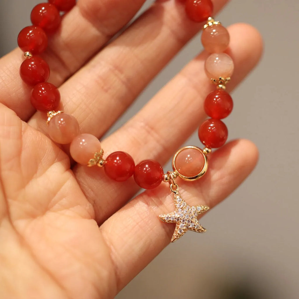 Handmade red agate and orange sunstone bracelet with star and cloud motifs