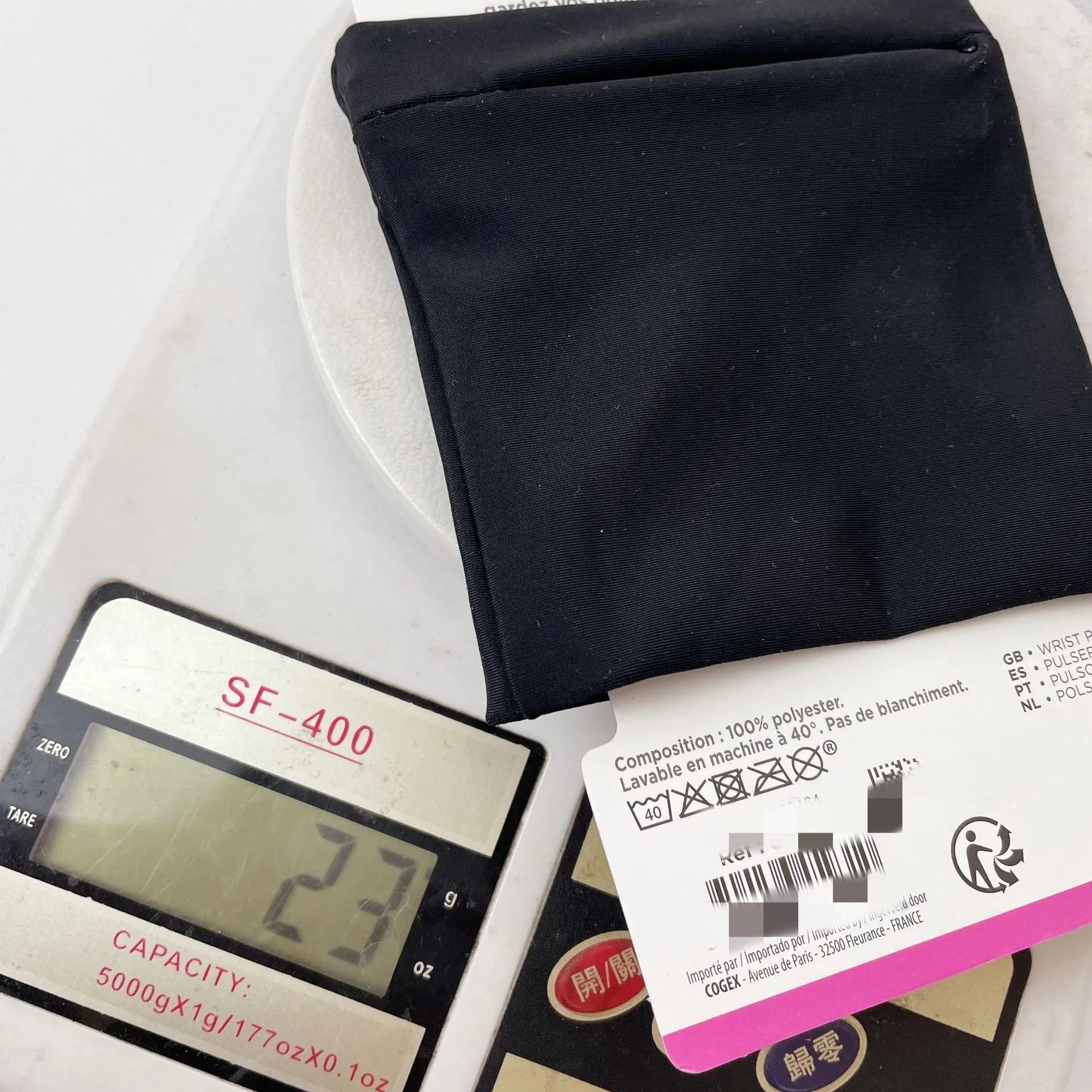 Adjustable fitness wrist bag with armband sleeve for mobile phone, shown in packaging.