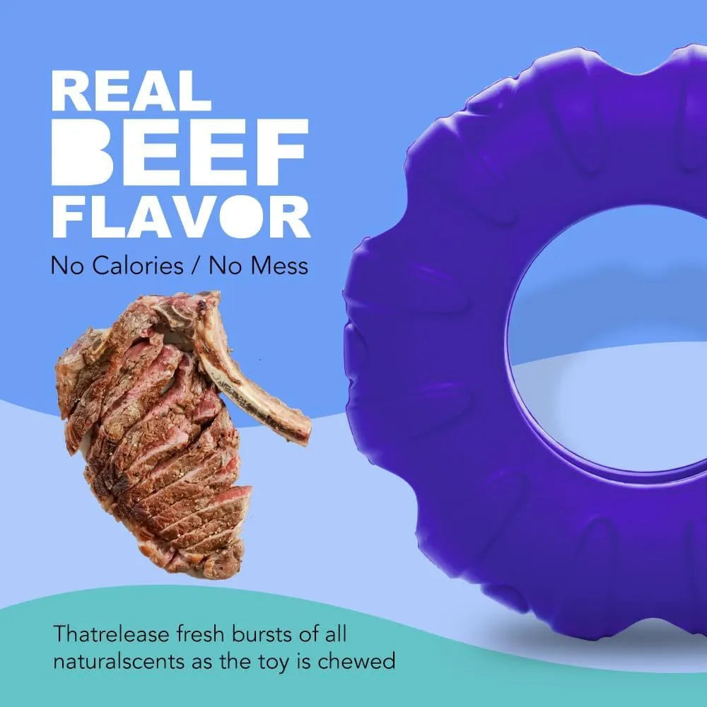 Blue natural rubber tyre-shaped dog chew toy with oval openings, for slow feeding and interactive play.