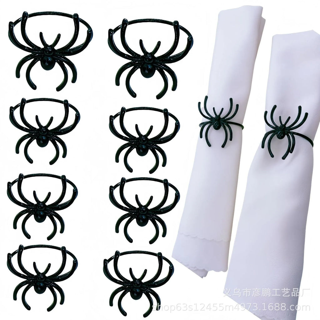 Set of six black alloy napkin rings with detailed spider sculpture for Halloween table decor.