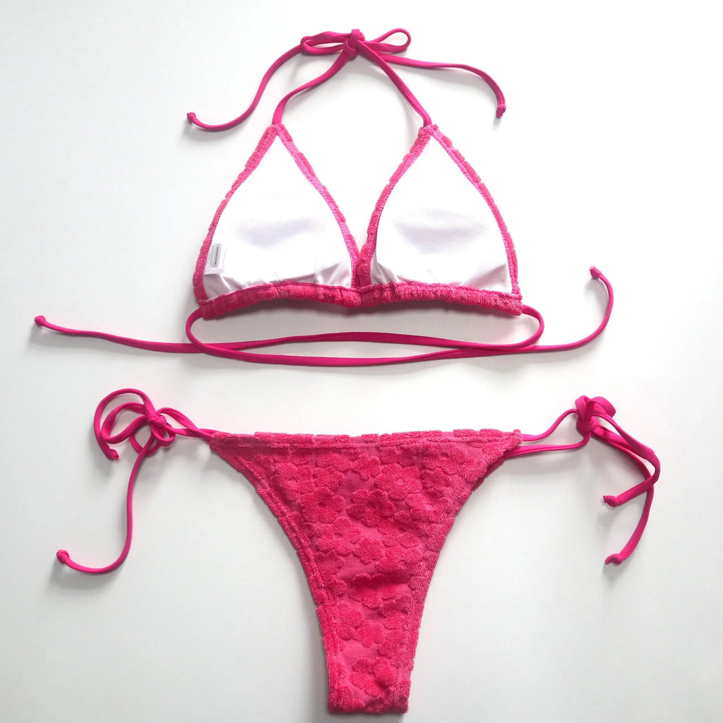 Women's bikini swimsuit with a lace-up back in flower fabric, shown in rose red and blue.
