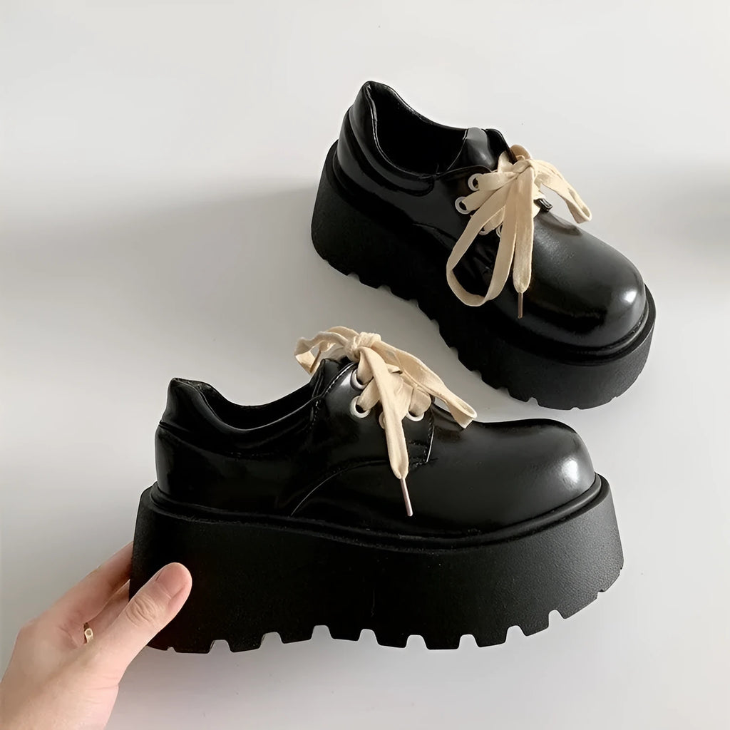 Matte black women's lace-up shoes with a chunky muffin heel and thick rubber sole