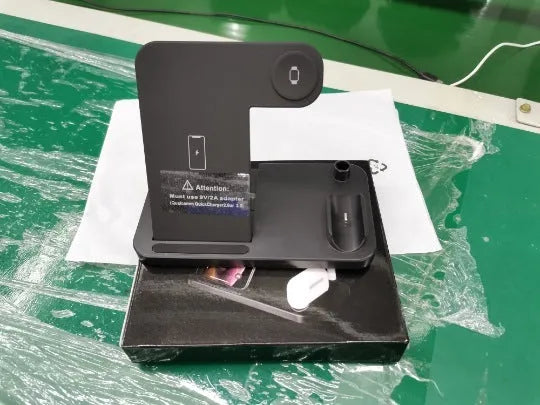 Foldable 4-in-1 wireless charging station in black, showing vertical phone stand and multiple charging pads for devices.