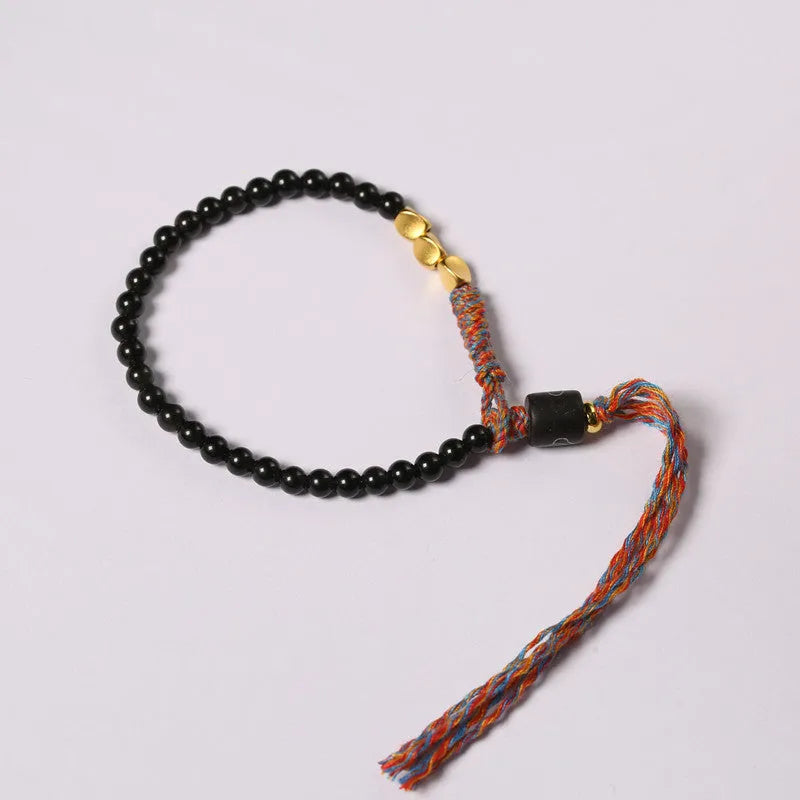 Hand-woven obsidian carrying strap bracelet showing textured surface and adjustable 15.5-16cm length