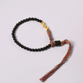 Hand-woven obsidian carrying strap bracelet showing textured surface and adjustable 15.5-16cm length