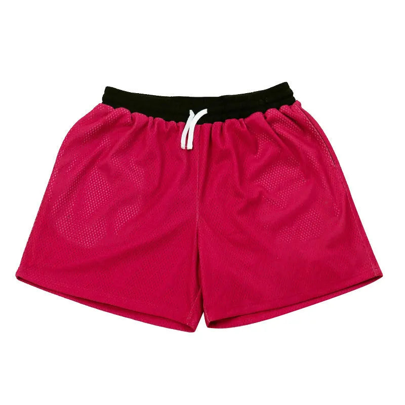 Men's solid colour quick-drying mesh sports shorts in black, shown for running.