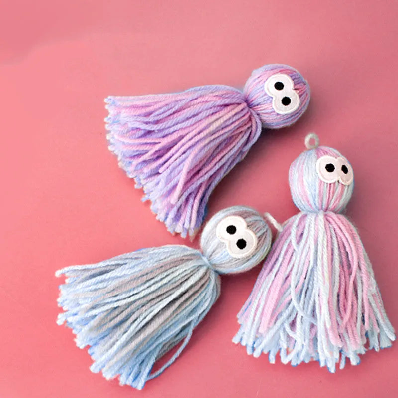 Four wool cat balls with hanging loops and teaser stick in blue grey, pink and blue, and pink purple colours