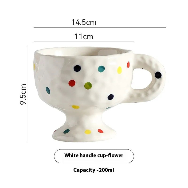 Handmade irregular solid colour ceramic mug on a table, showing its unique shape.