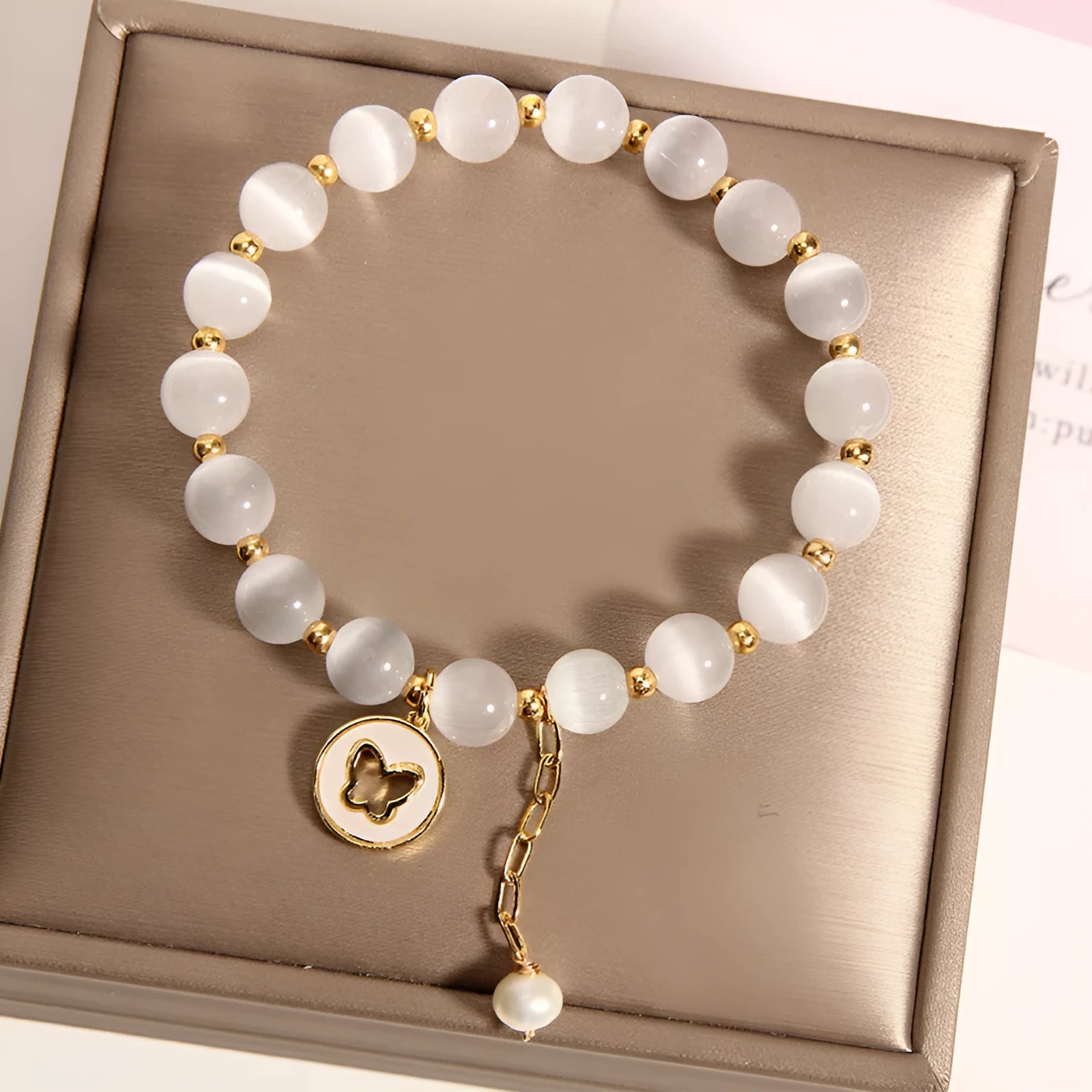 White cat's eye crystal bracelet with geometric design on a wrist