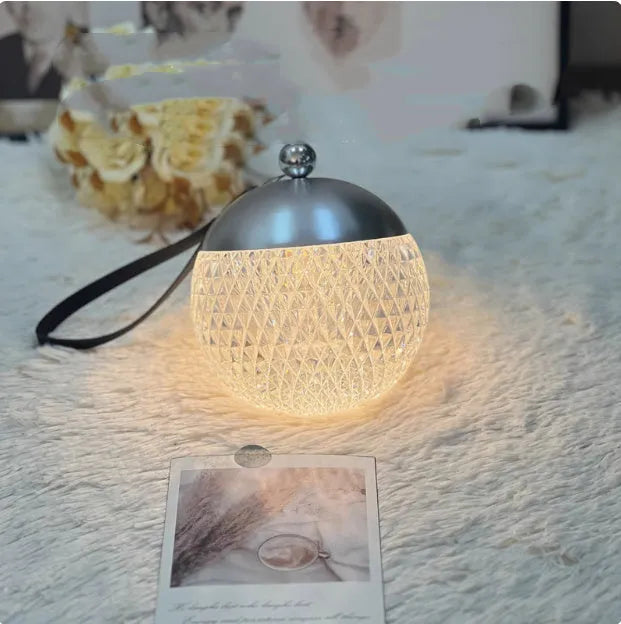 Small cylindrical portable LED night lamp with a touch dimmer in a choice of five colours.