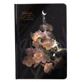 A5 notebook with luminous reflective cover open to show pages with colourful illustrated backgrounds.