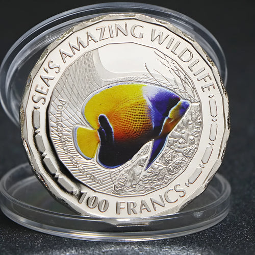 Set of eight silver plated commemorative coins with tropical fish and marine animal designs, 40mm diameter, in acrylic box