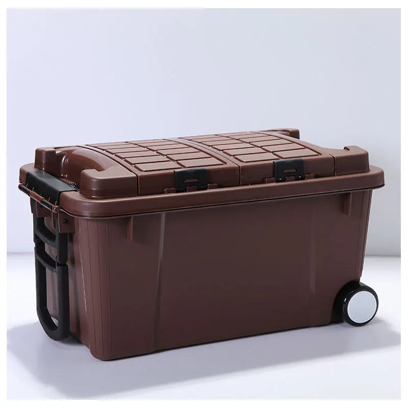 Large orange plastic storage box with wheels and an extended pull handle on a grey floor.