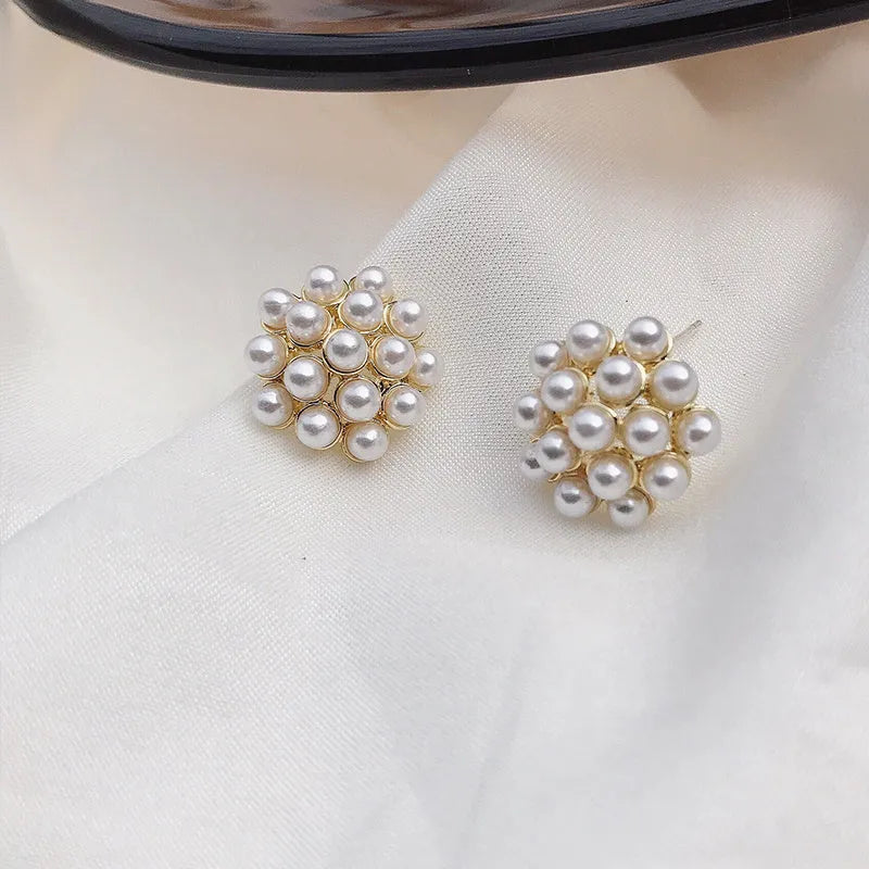 Gold pineapple and starfish pearl Korean style drop earrings with alloy electroplating and inlaid gems.