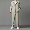 Grey loose-fit hooded sun-protective jacket and trousers set on a hanger