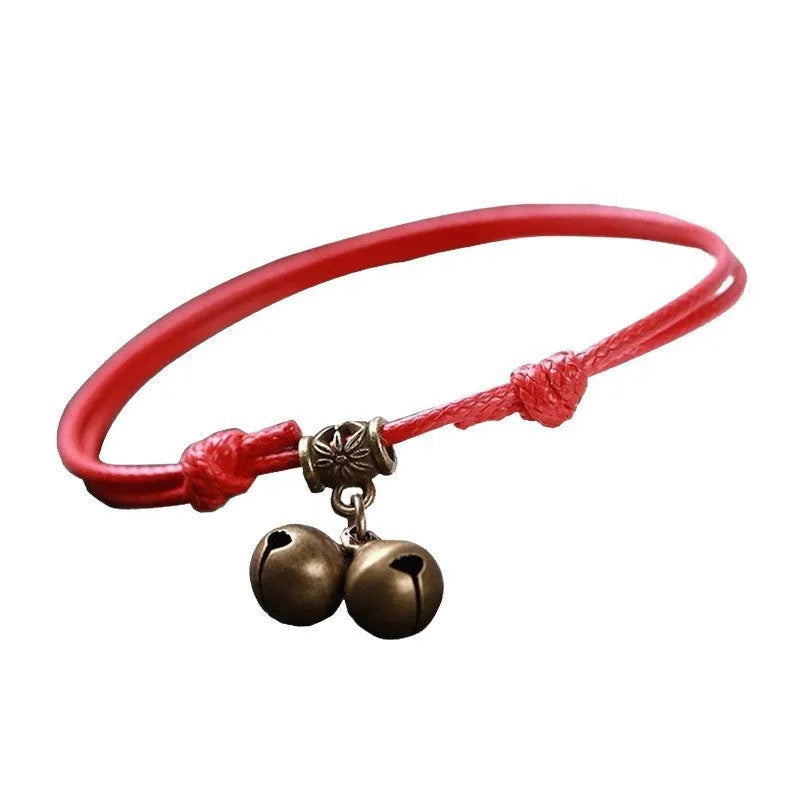 A nylon rope dog collar with a brass buckle shown alongside a version with a brass bell, in black, red, and coffee colours.