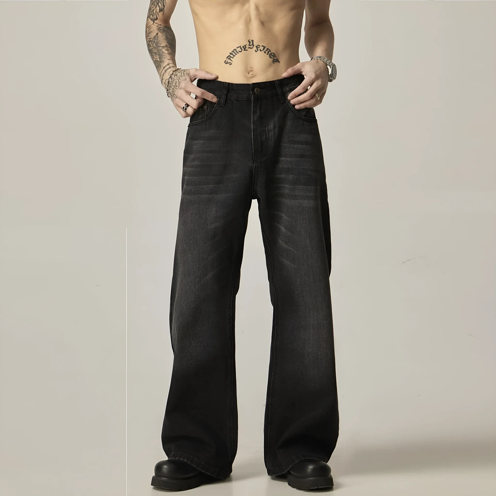 Black loose straight-leg jeans with a retro light wash and zip fly closure laid flat.
