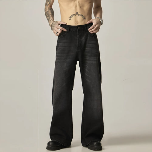 Black loose straight-leg jeans with a retro light wash and zip fly closure laid flat.