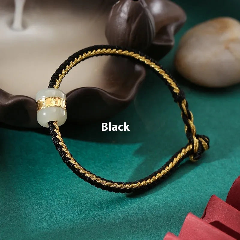 Hand-woven bracelet with Hetian jade inlay gold tone finish geometric shape on dark background
