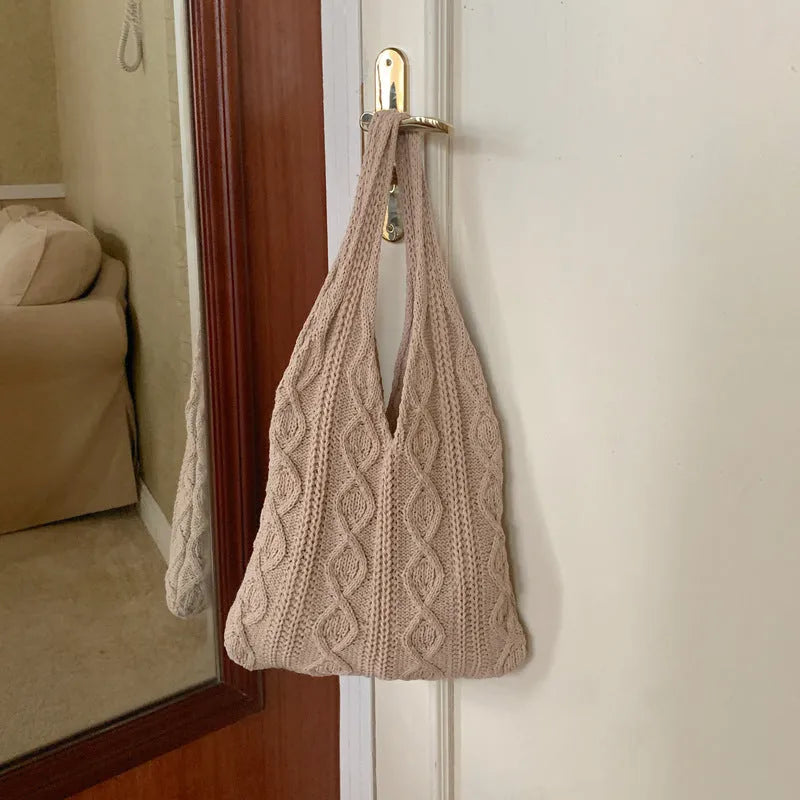 GWomen retro crochet shoulder tote bag in a solid colour, showing knitted texture and double strap connectors.