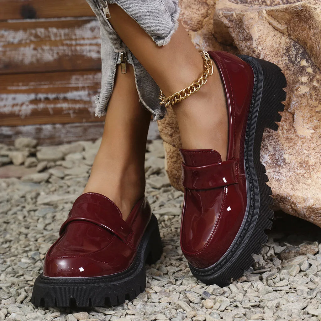 British-style slip-on loafers with a chunky mid heel and thick rubber platform sole.