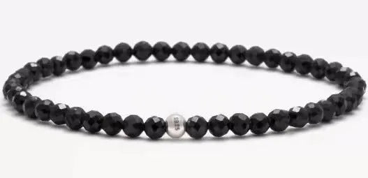 Geometric unisex bracelet with 4mm black agate, blue san, and obsidian beads on a wrist.