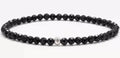 Geometric unisex bracelet with 4mm black agate, blue san, and obsidian beads on a wrist.