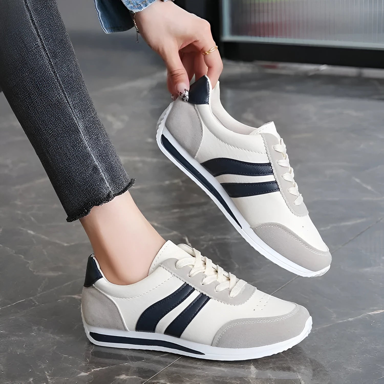 Blue and red low-top lace-up running sneakers with rubber soles and mesh upper