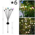 Solar-powered LED firefly garden spike light with multiple heads and a press-in ground plug on grass.