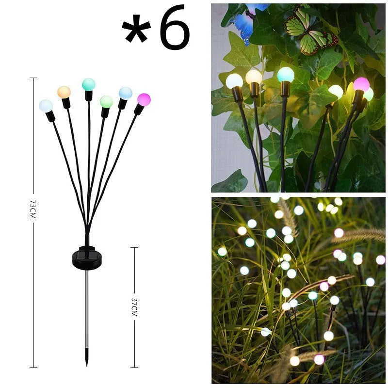 Solar-powered LED firefly garden spike light with multiple heads and a press-in ground plug on grass.