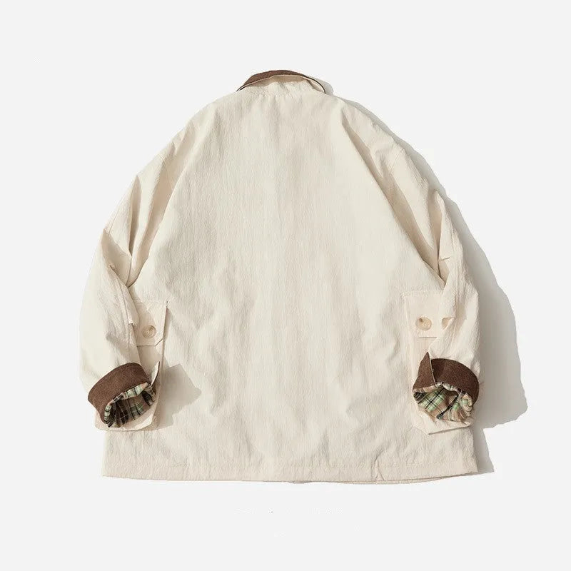 Casual apricot and green polyester jacket with side seam pockets on a hanger.