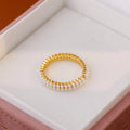 Gold electroplated pearl ring with open mouth geometric design on female hand