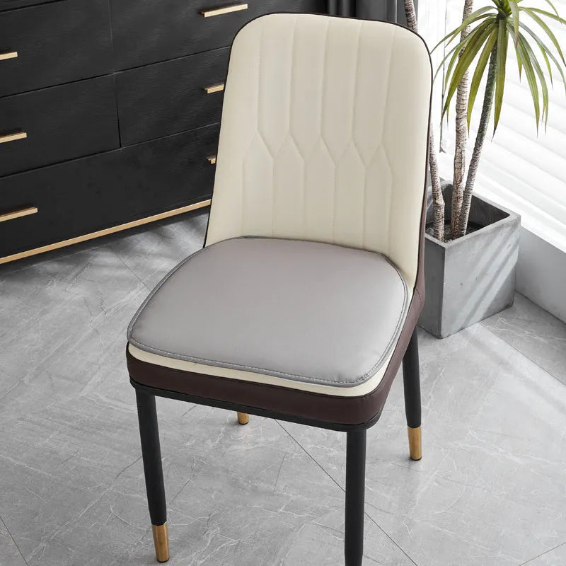 Leather horseshoe-shaped seat cushion in beige colour showing thickness and shape