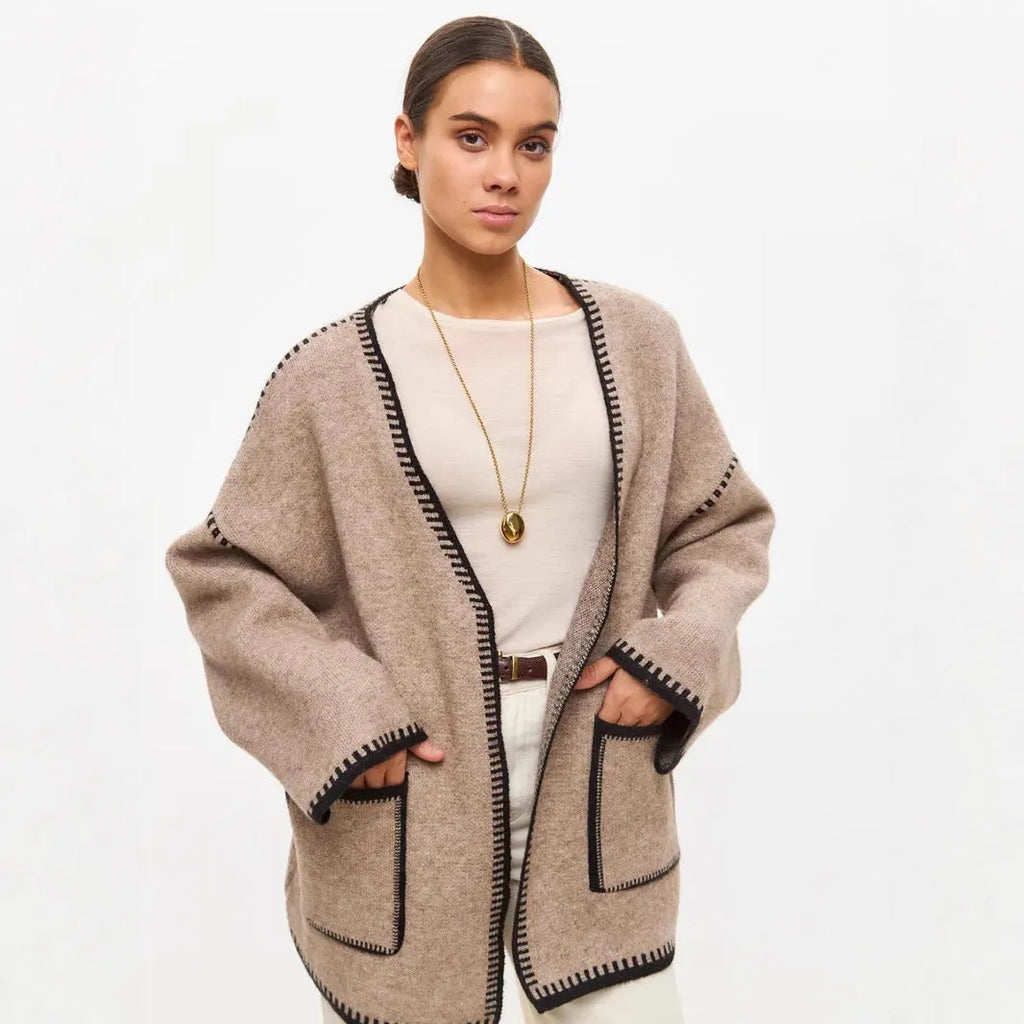 Lace-up front knitted cardigan in black, camel, or white, showing loose fit and thick fabric.