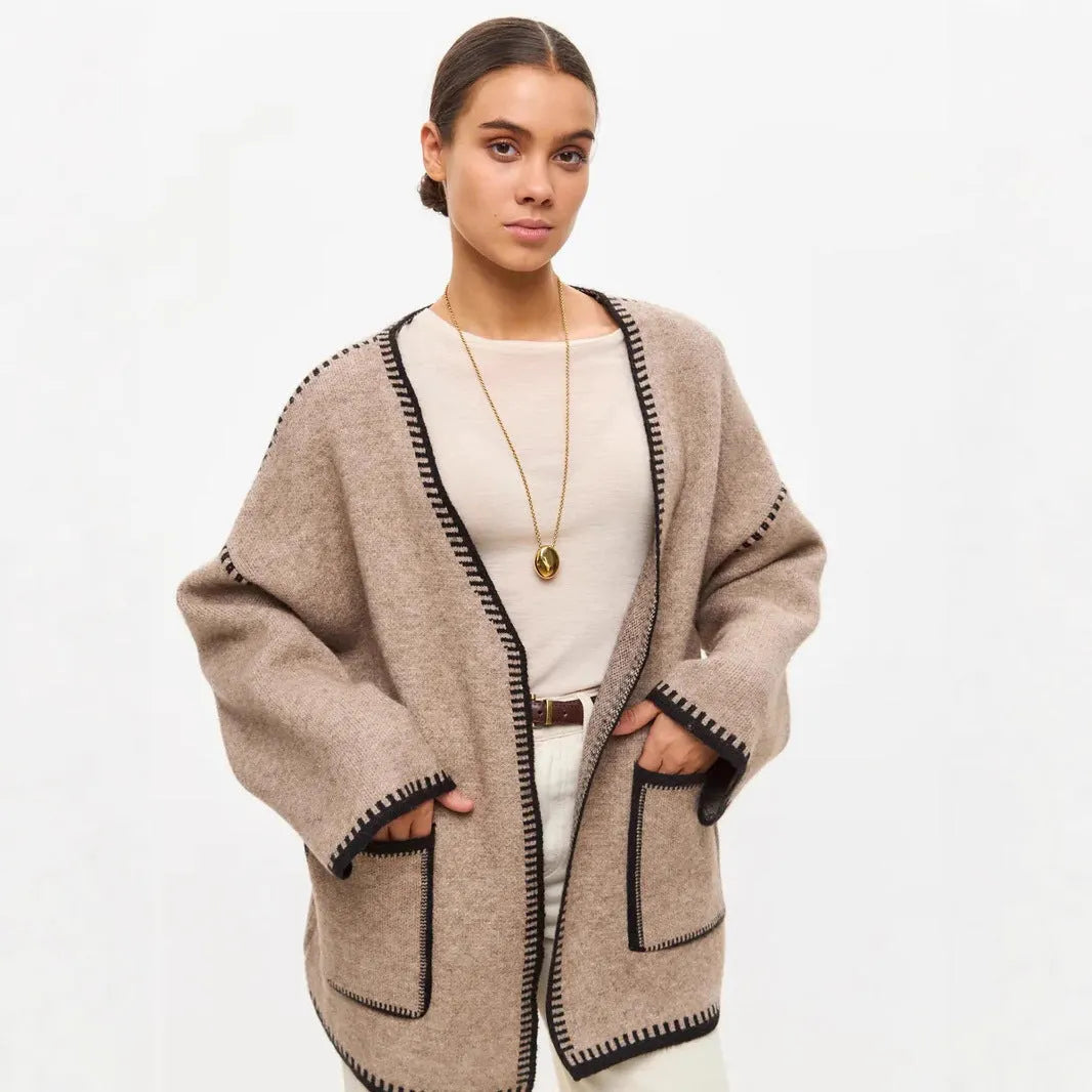 Lace-up front knitted cardigan in black, camel, or white, showing loose fit and thick fabric.