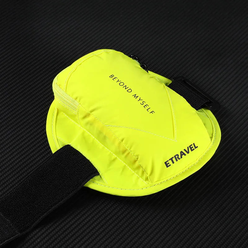 Black reflective running arm bag with adjustable strap, shown on a runner's arm at dusk.