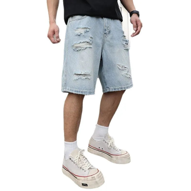 Men's light blue ripped denim shorts with distressed detailing and loose straight cut