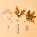 Three small steel wire insect-shaped replacement heads for cat wand toys on a white background.