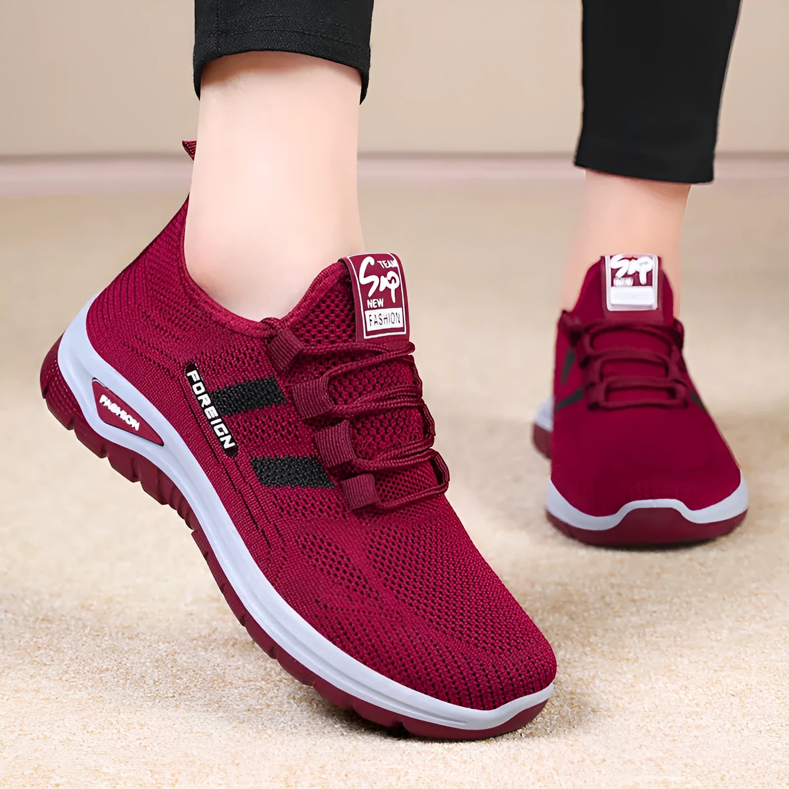 Women's low-top casual sneakers in black with breathable mesh upper and flat PVC sole