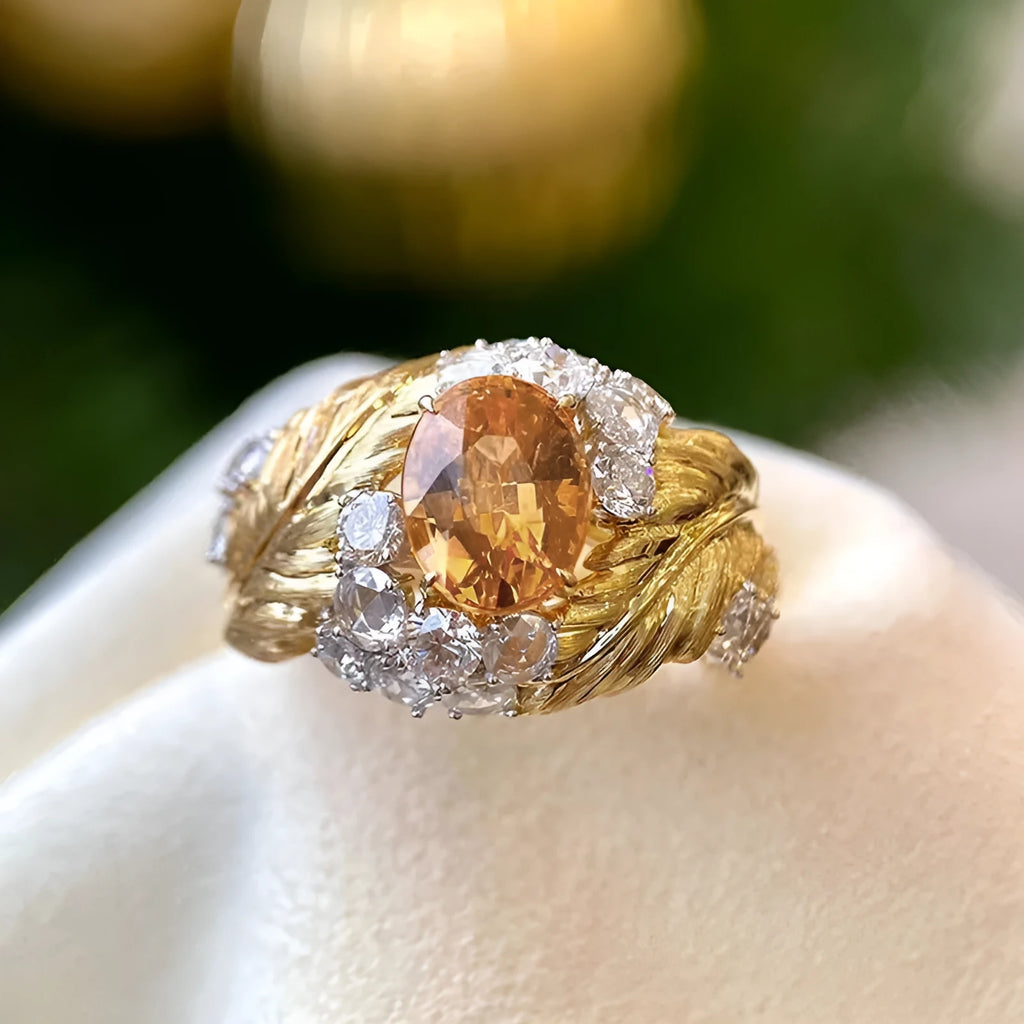 Embossed feather ring with geometric design and inlaid yellow zircon in gold colour