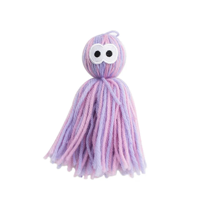 Four wool cat balls with hanging loops and teaser stick in blue grey, pink and blue, and pink purple colours
