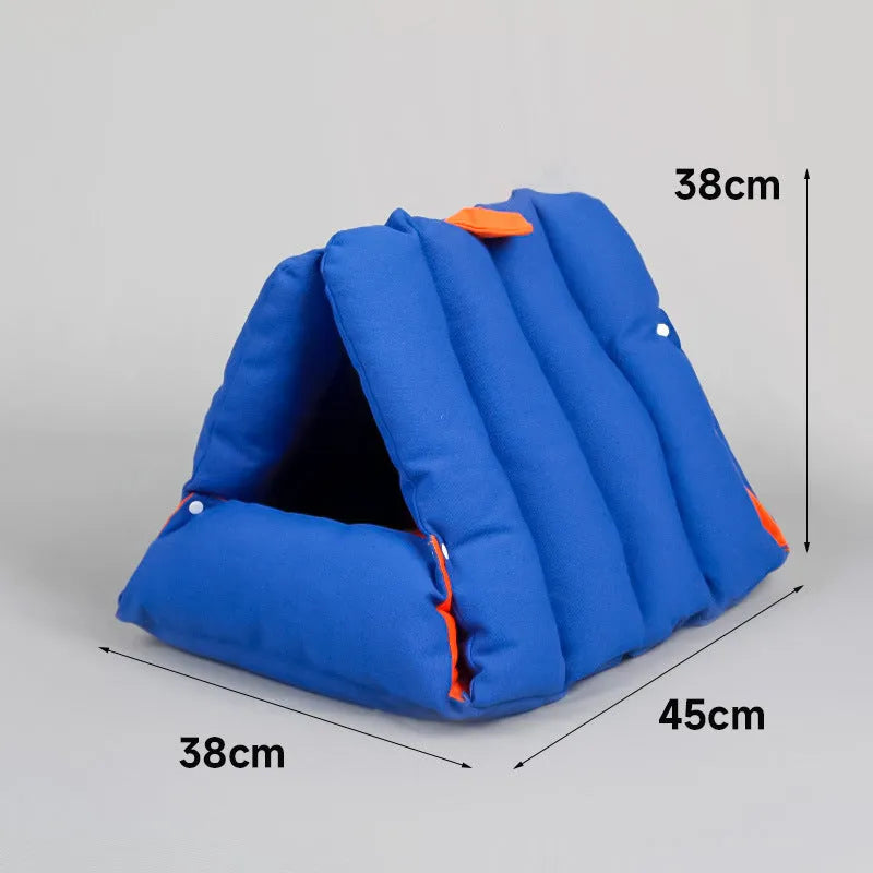 Blue triangular cat bed with raised sides and visible connection holes on a wooden floor.
