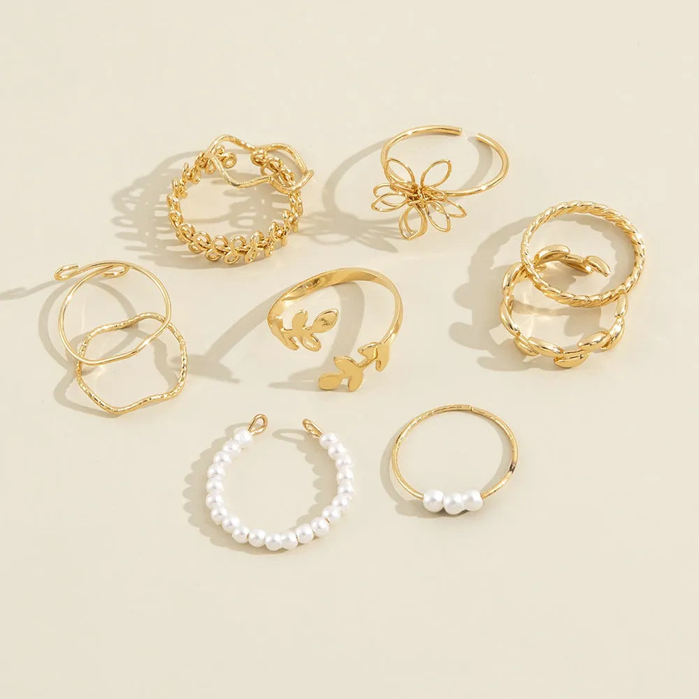 Gold colour openwork flower ring with detailed floral design and glossy electroplated finish