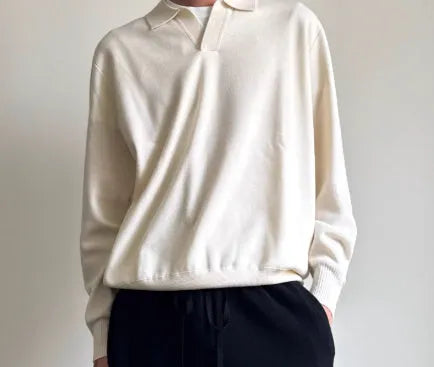 Pure wool polo sweater with lapel collar in navy blue on a hanger.